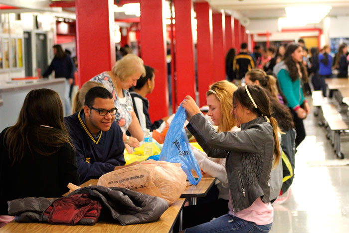 Several students helped create sleeping mats for the homeless by weaving plastic bags in the East Leyden cafeteria during Saturdays Make A Difference Day. 