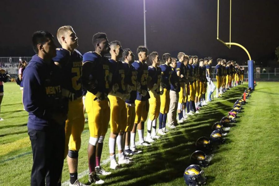 Varsity Football Locking Arms During National Anthem before Hinsdale South.