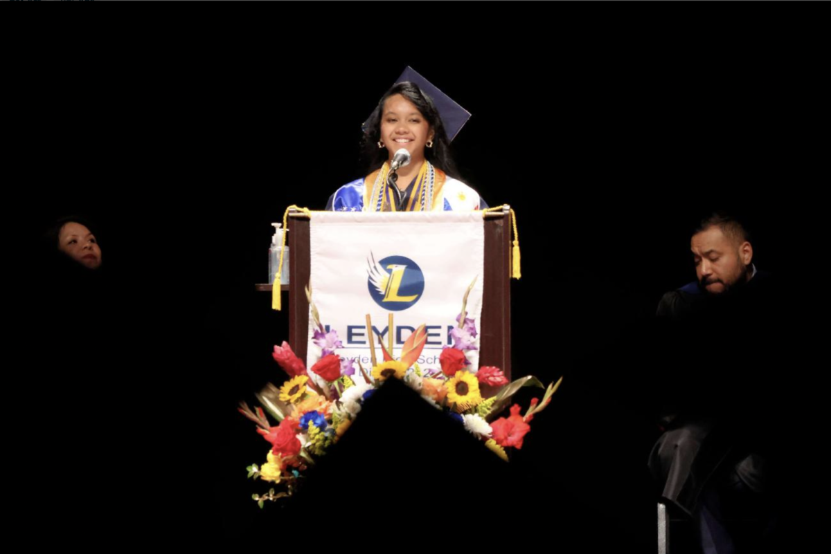 Claudine Ricana giving student speech at graduation. 